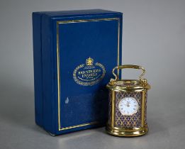 A cased Halcyon Days enamel and brass commemorative miniature carriage clock, Lloyds of London