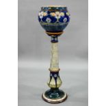 An Edwardian Royal Doulton stoneware jardiniere on stand, impressed and painted with stylised floral