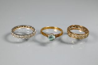 An 18ct yellow gold ring set with single aquamarine, size O, a diamond set white metal eternity ring