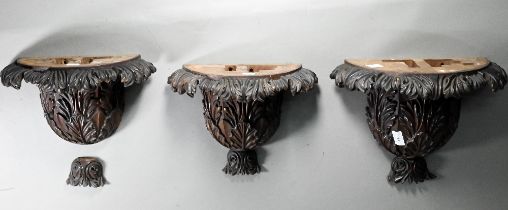 A trio of carved hardwood wall brackets, one large 27 cm high, two 24 cm high, all a/f (3)