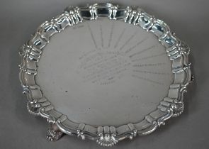 A silver salver with shell and scroll moulded rim and three bracket feet, Walker & Hall, Sheffield