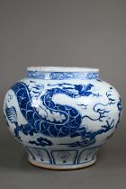 A large Chinese Ming style blue and white jar, painted in underglaze blue with a large dragon