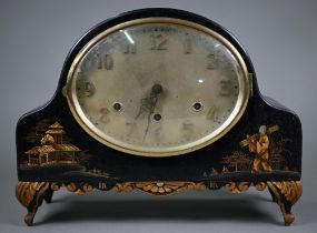 An early 20th century chinoiserie cased black and gilt lacquered mantel clock with continental three