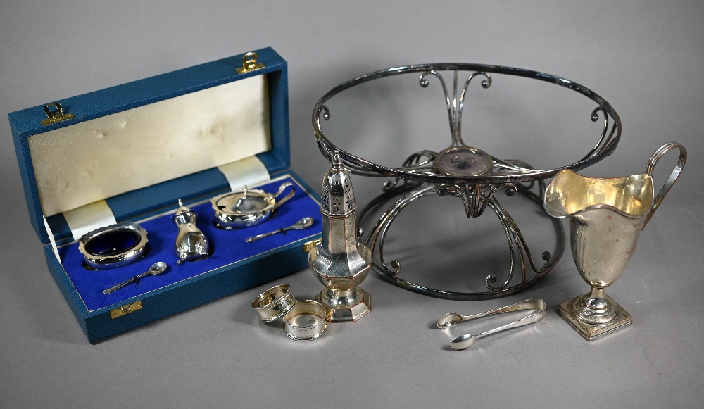 A cased silver three-piece condiment c/w spoons, Birmingham 1962, a pair of sugar tongs and a pair