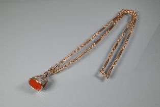 A rose-gold fetter link Albert chain with swivel and cornelian set fob attached, 37 cm long (