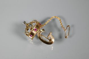 A 1960s yellow metal brooch in form of a crown above the initial 'G', the crown set with rubies