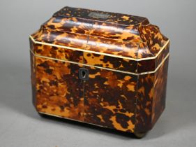 A Regency tortoiseshell sarcophagus tea caddy with moulded top enclosing two lidded compartments, on