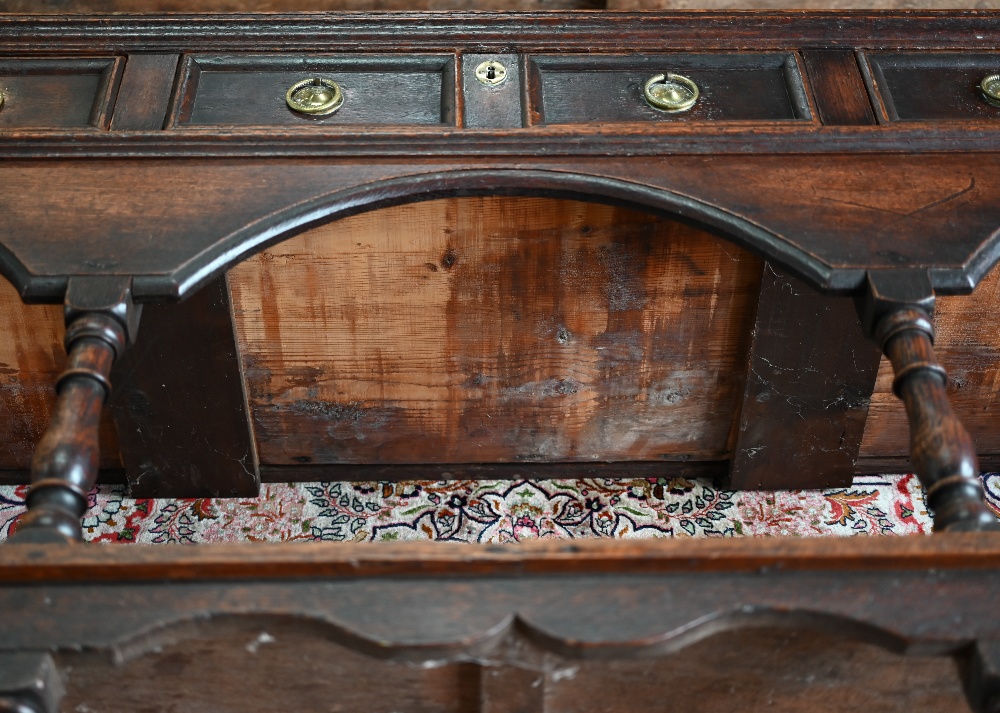 An antique oak low dresser with three double moulded front drawers over a triple arched apron, - Image 16 of 23