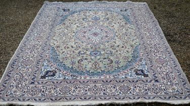 An old Indo-Persian Nian carpet, the cream ground centred with a pale green ground floral medallion,