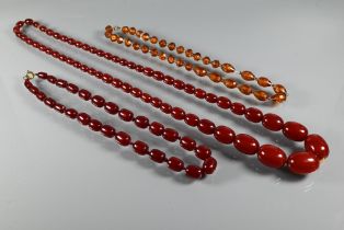 Three amber bead necklaces - one with graduated faceted beads, and two with cherry red graduated