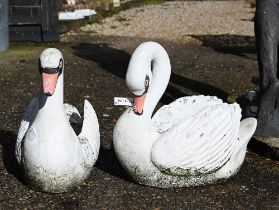 A companion pair of weathered and painted cast stone garden swan planters (2)