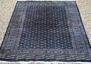 A large Pakistani Turkoman design carpet, the blue ground with repeating gul design and multi-