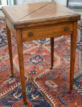 An Edwardian walnut crossbanded envelope card table with frieze drawer and tapering square