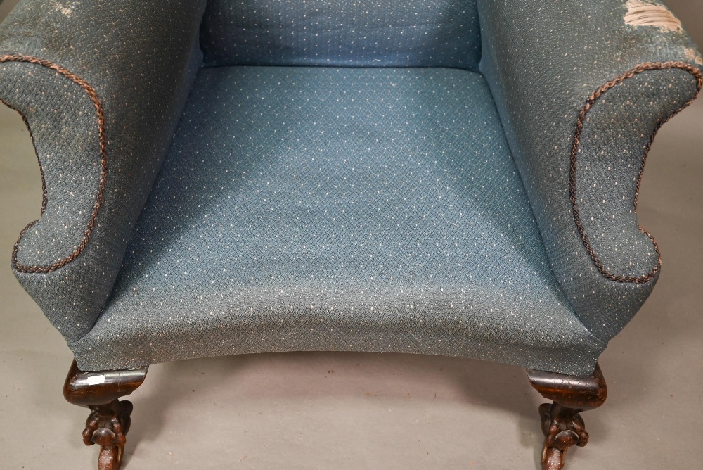 A traditionally upholstered Queen Anne style wing armchair, with concave seat front, raised on short - Image 13 of 14