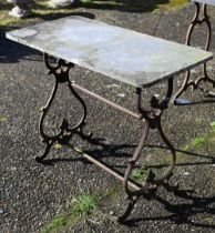 An old weathered stone top cast iron base potting table