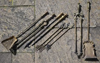 Various brass fire irons, toasting forks, etc