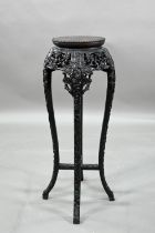 A 19th century Chinese circular jardiniere stand intricately carved and pierced with prunus