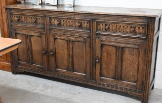 An Old Charm style oak sideboard with three drawers over panelled cupboard doors,180 x 42 x 90 cm