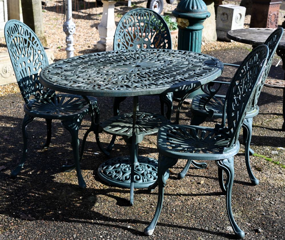 A Victorian style green painted five-piece green terrace dining set comprising a table and four