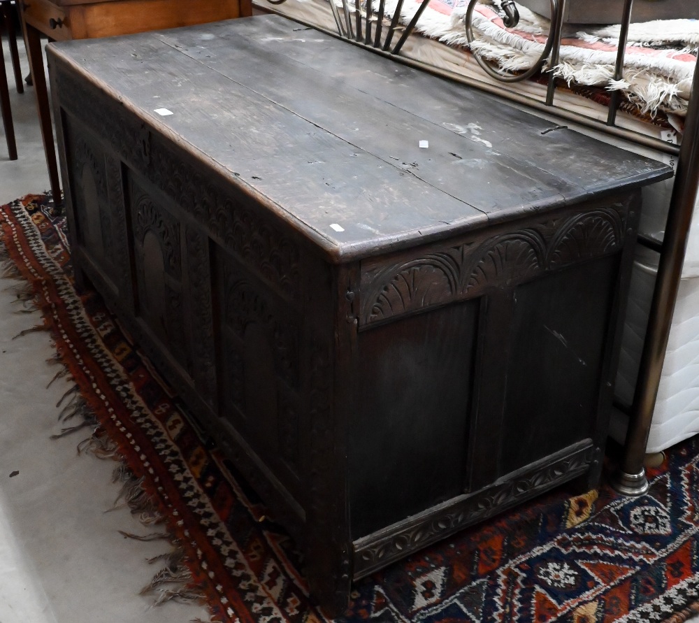 A large 18th century carved oak coffer/blanket chest (a/f), 132 cm wide x 60 cm deep x 62 cm high