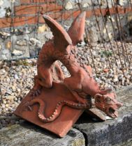 A reconstituted aged terracotta 'dragon' ridge tile, 43 cm high