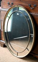 A Victorian oval giltwood and composite framed mirror, 97 cm x 74 cm