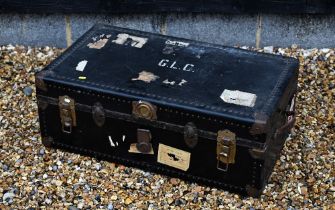 A vintage navy blue steamer/school trunk stenciled ownership, initials 'G.L.C'