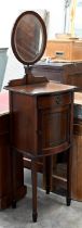 A mahogany vanity stand with adjustable oval mirror, drawer and cupboard on tapering square