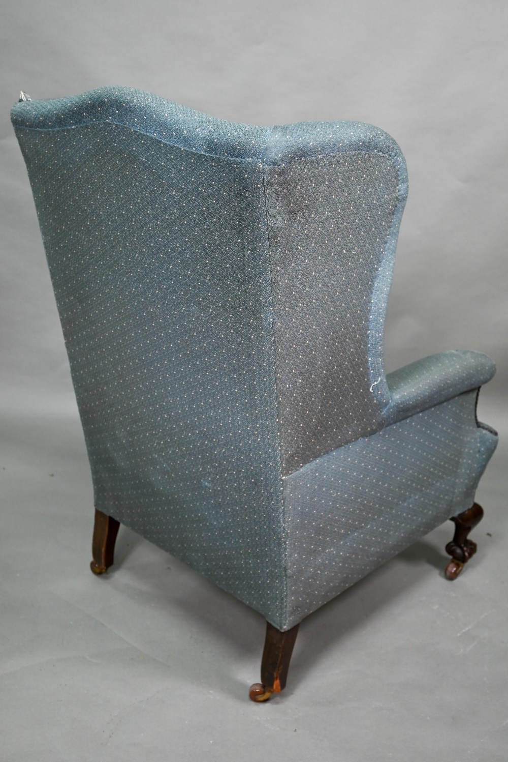 A traditionally upholstered Queen Anne style wing armchair, with concave seat front, raised on short - Image 14 of 14