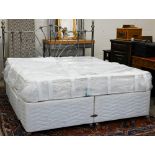 A super king divan bed with Dream's Solstice medium firm mattress and metal headboard, appears
