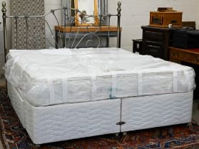 A super king divan bed with Dream's Solstice medium firm mattress and metal headboard, appears
