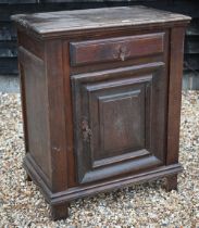 An 18th century Italian walnut side cabinet, with frieze drawer over a mitre framed door, raised