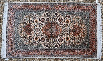 An Indian Kashmir part-silk kashan design rug, of traditional floral design on cream ground, and