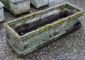 A Georgian style weathered cast stone garden trough planter