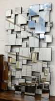 A contemporary wall mirror with multi-bevelled square plates, 140 x 84 cm