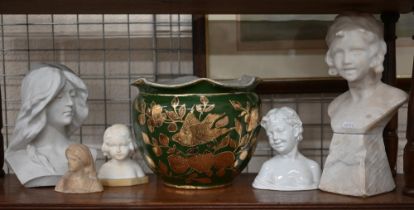 A carved alabaster bust of a child on plinth, to/w a smaller example and a bust of a woman, two