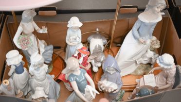 Four Lladro figures - girl reading in a chair, young girl sleeping in a rocking chair, puppy and boy