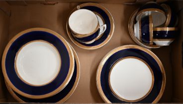 A Crown Ducal tea/dinner service with blue and gilt borders, 36 pieces (box)