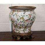 An Asian pottery jardiniere printed with birds, flowers and foliage, with metal rim and foot, 31
