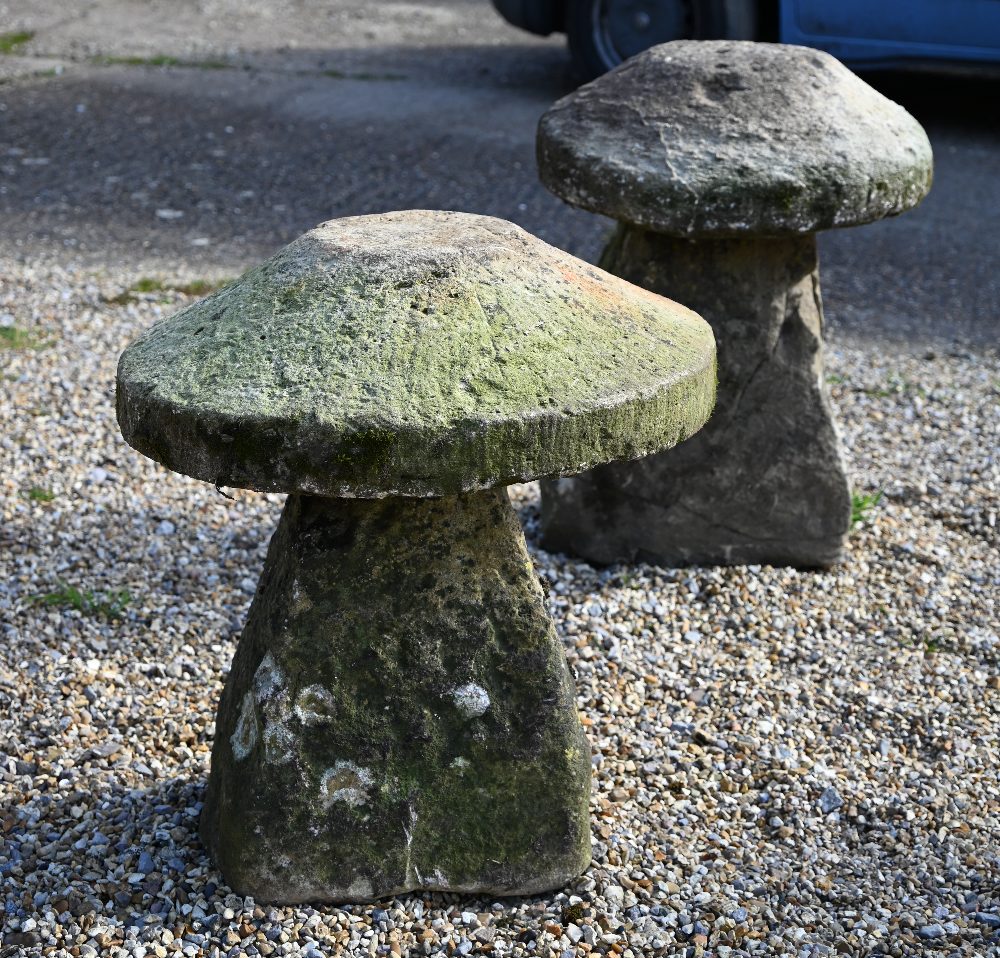 Two antique weathered cut stone low staddle stones, 65 cm and 55 cm high (2)