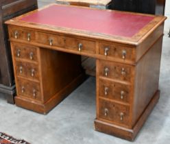 A Victorian burr-walnut twin-pedestal desk with red leather top over nine drawers, 108 cm wide x