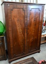 A 19th century mahogany compactum wardrobe with panelled doors enclosing hanging space and five