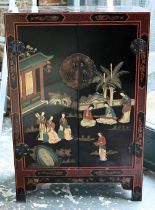 A Japanese black lacquered and polychrome pictorial decorated cabinet, 62 cm x 31 cm x 92 cm h,