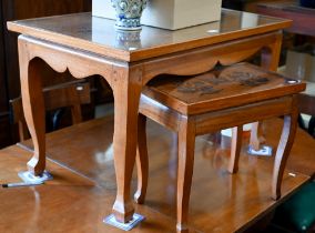 A Chinese hardwood coffee table, the top with copper filigree inset dragon under glass, on shaped