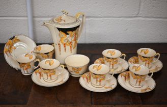 An Art Deco Crown Devon pottery coffee service, printed and painted with wisteria, including