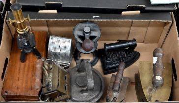 A vintage boxed student's microscope, to/w three antique 'hot stone' irons and a flatiron, a spice/