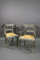 A pair of Indian metal clad dining hall chairs, with rams head back terminals over sabre front