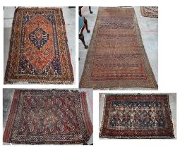 Four old worn Persian rugs - Turkoman with repeat gul design on red ground, 165 x 115 cm; Balouch