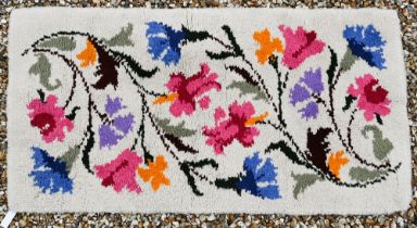 A vintage thick-piled wool floral rug, 134 x 69 cm