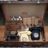 A German vintage leather suitcase, labelled for Moritz Muller, Leipzig, to/w two vintage telephones,